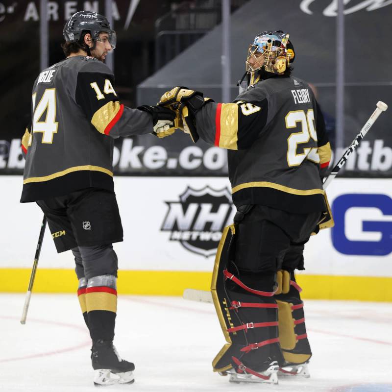 Vegas Golden Knights defenseman Nicolas Hague (14) and goaltender Marc-Andre Fleury (29) bump g ...