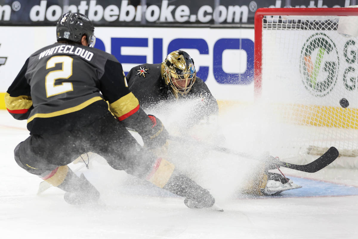 Vegas Golden Knights goaltender Marc-Andre Fleury (29) and defenseman Zach Whitecloud (2) watch ...