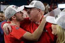 Kansas City Chiefs coach Andy Reid embraces his son Britt Reid, linebacker coach, after the NFL ...