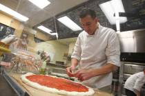 Restaurant owner and chef Giovanni Mauro prepares a pizza at Old School Pizzeria in 2013. (Chas ...