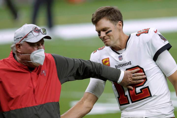 In this Jan. 17, 2021, file photo, Tampa Bay Buccaneers coach Bruce Arians, left, speaks with q ...