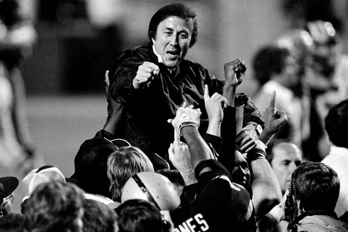 FILE - In this Jan. 23, 1984, file photo, coach Tom Flores gestures to members of the Los Angel ...