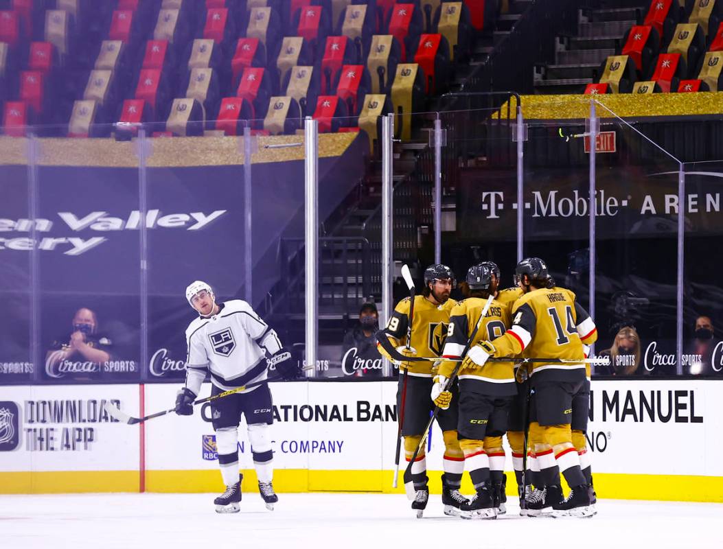 Golden Knights players celebrate a goal by defenseman Zach Whitecloud (2) during the first peri ...