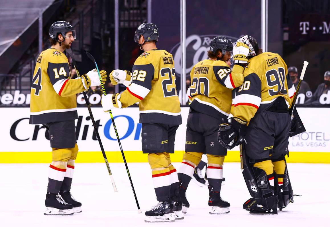 Golden Knights center Chandler Stephenson (20) celebrates with goaltender Robin Lehner (90) aft ...