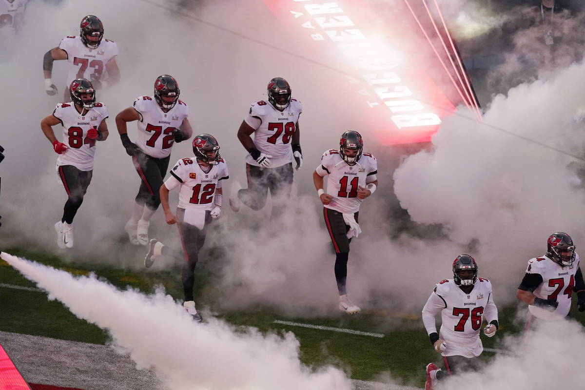 Tampa Bay Buccaneers' Tom Brady (12) runs onto the field with his teammates before the NFL Supe ...