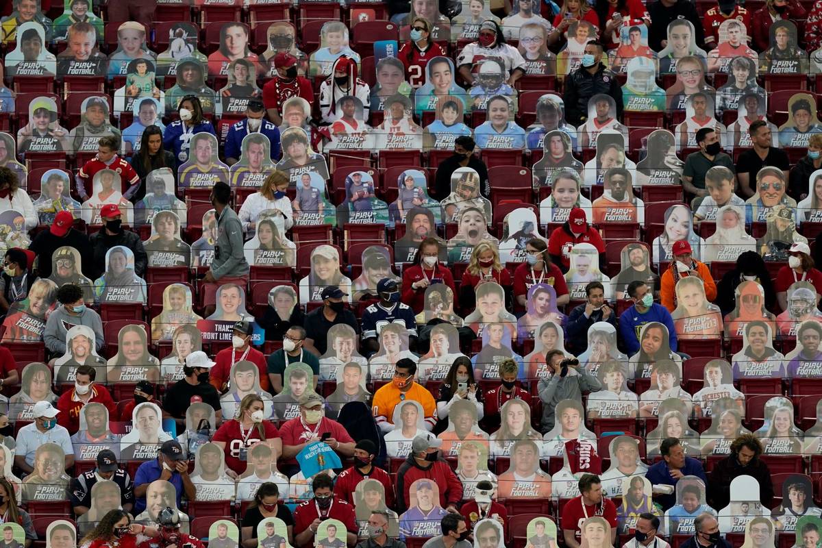 Fans sit among cardboard cutouts before the NFL Super Bowl 55 football game between the Kansas ...