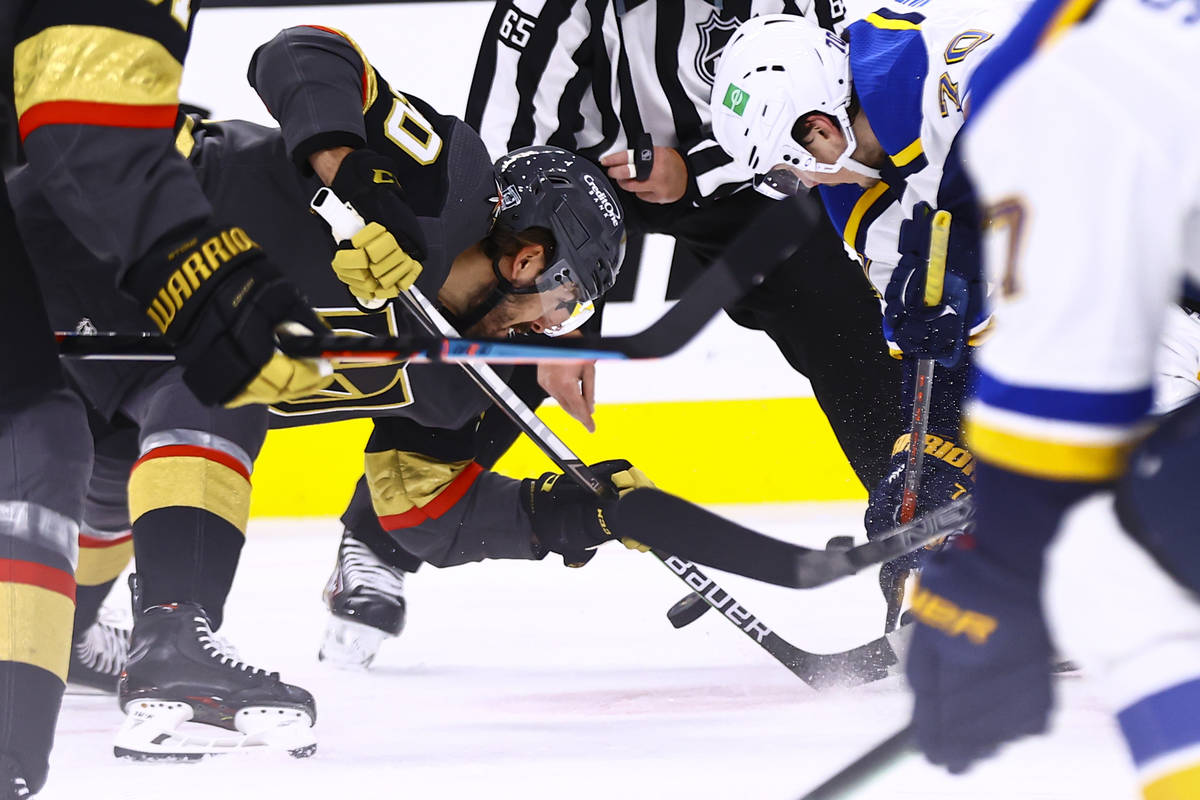 Golden Knights center Chandler Stephenson (20) and St. Louis Blues center Oskar Sundqvist (70) ...