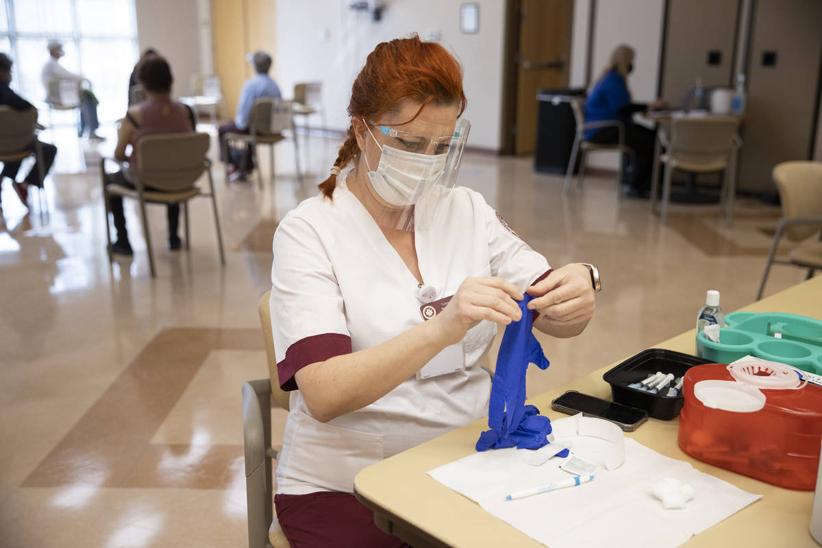 Tasey Shaul, student nurse at Roseman University of Health Sciences, gets ready to administer t ...