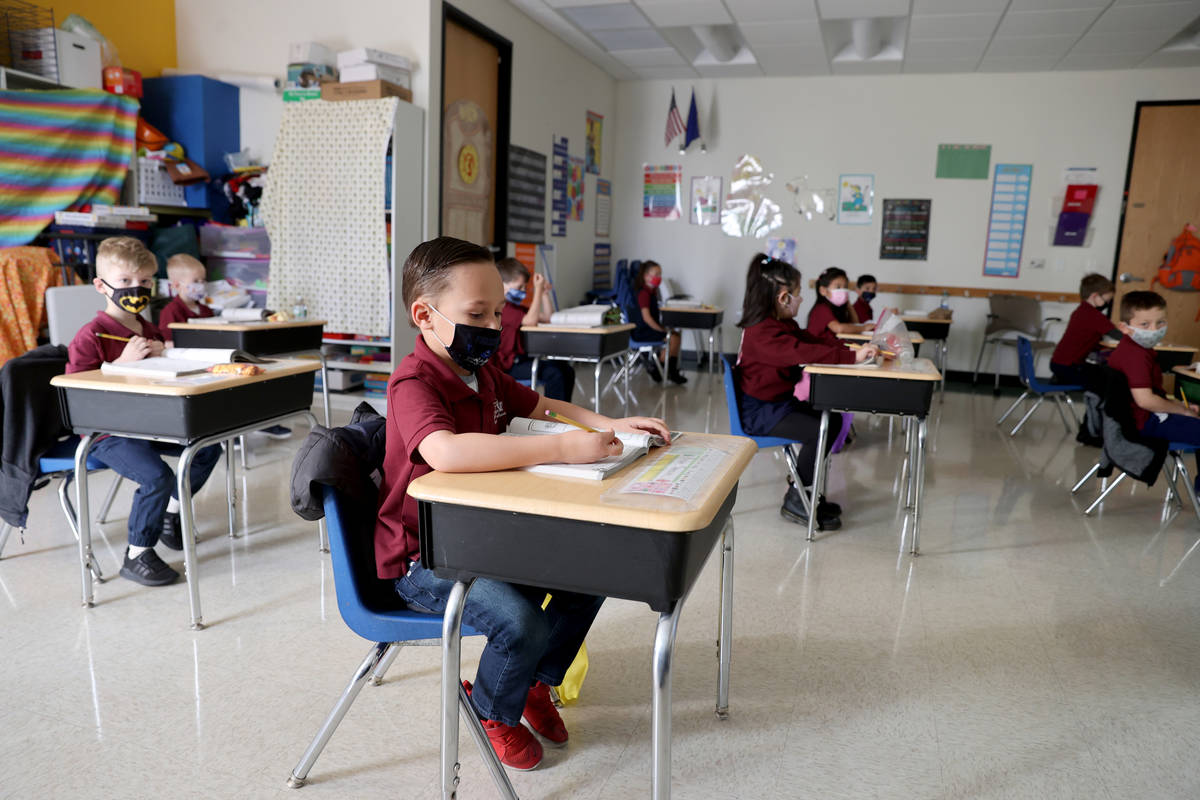 Nolan Sumsion, 6, center, in Tammy Schuster's kindergarten class during school at Coral Academy ...