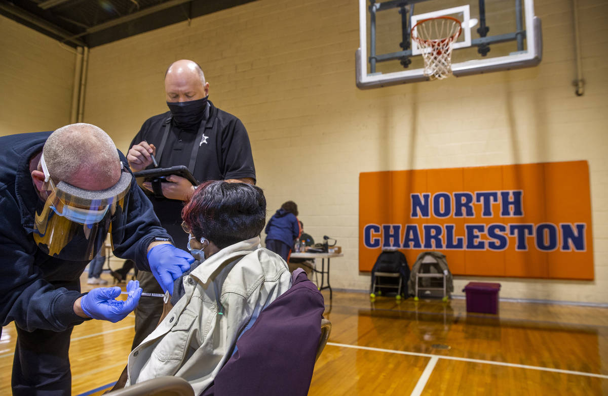 (From left) Kanawha County EMT Jeff Broyles and Sheriff's officer Doug Beasley team up to deliv ...