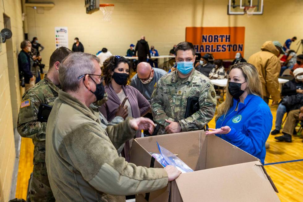 Dr. Sherri Young, right, confers with West Virginia Guardsmen and Kanawha County personnel as t ...