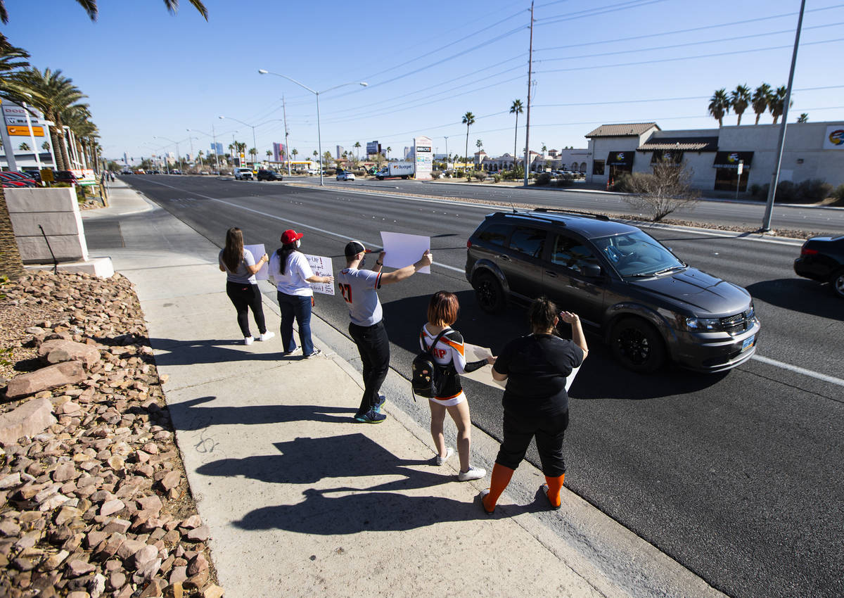 Student athletes and parents participate in a rally to urge school district officials to bring ...