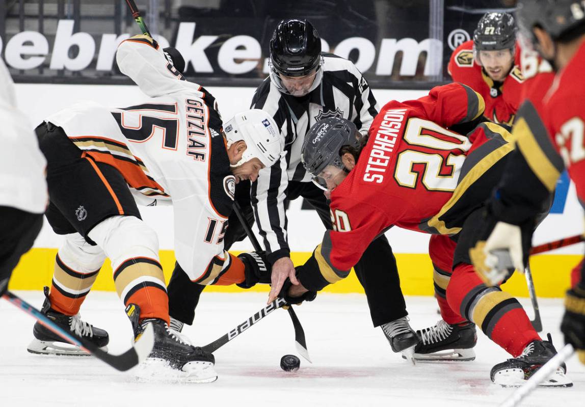 Vegas Golden Knights center Chandler Stephenson (20) faces off against Anaheim Ducks center Rya ...