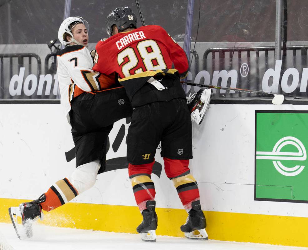 Vegas Golden Knights left wing William Carrier (28) collides with Anaheim Ducks defenseman Ben ...