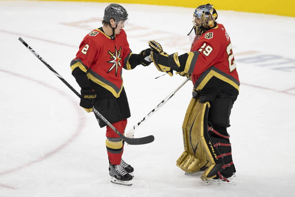 Vegas Golden Knights defenseman Zach Whitecloud (2) celebrates with Vegas Golden Knights goalte ...