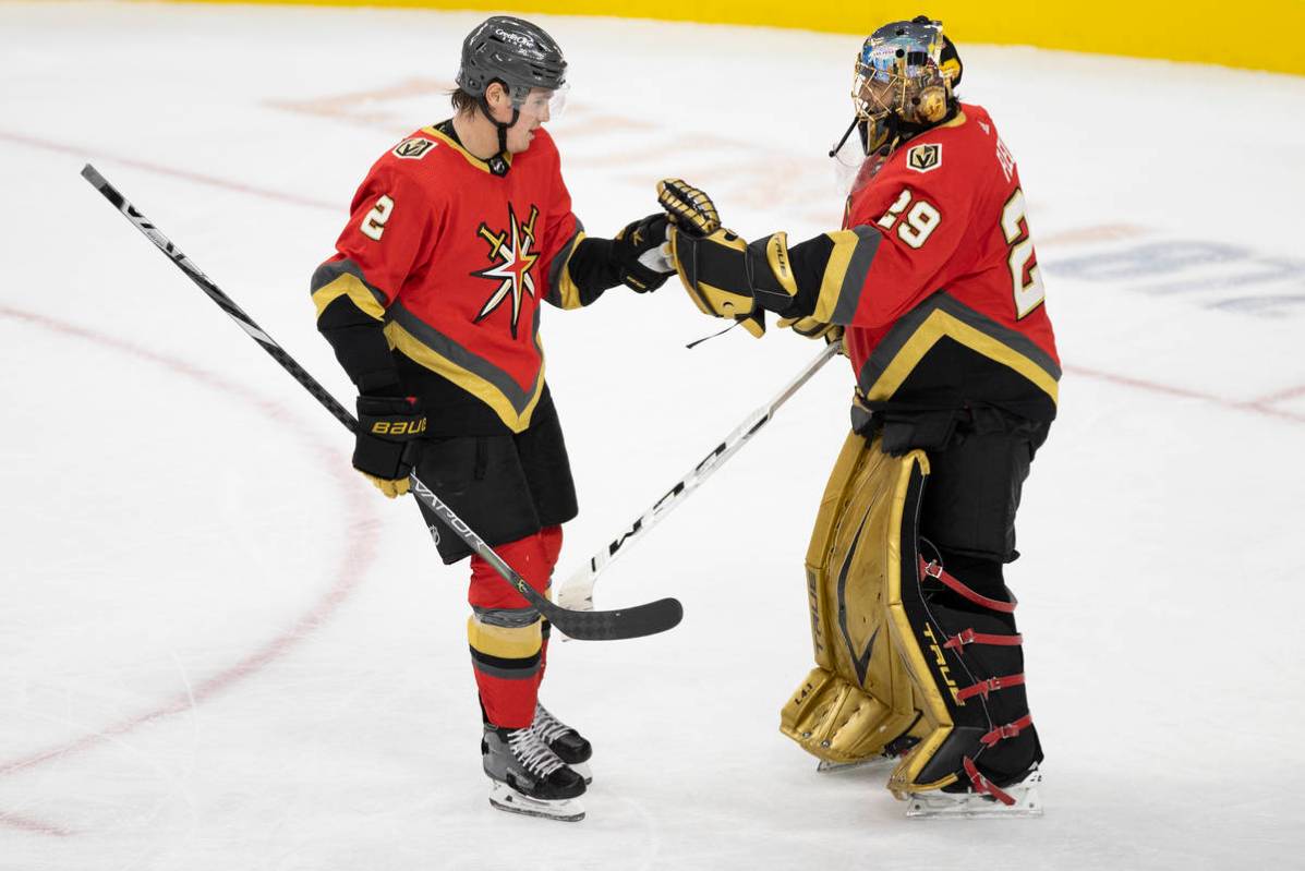 Vegas Golden Knights defenseman Zach Whitecloud (2) celebrates with Vegas Golden Knights goalte ...