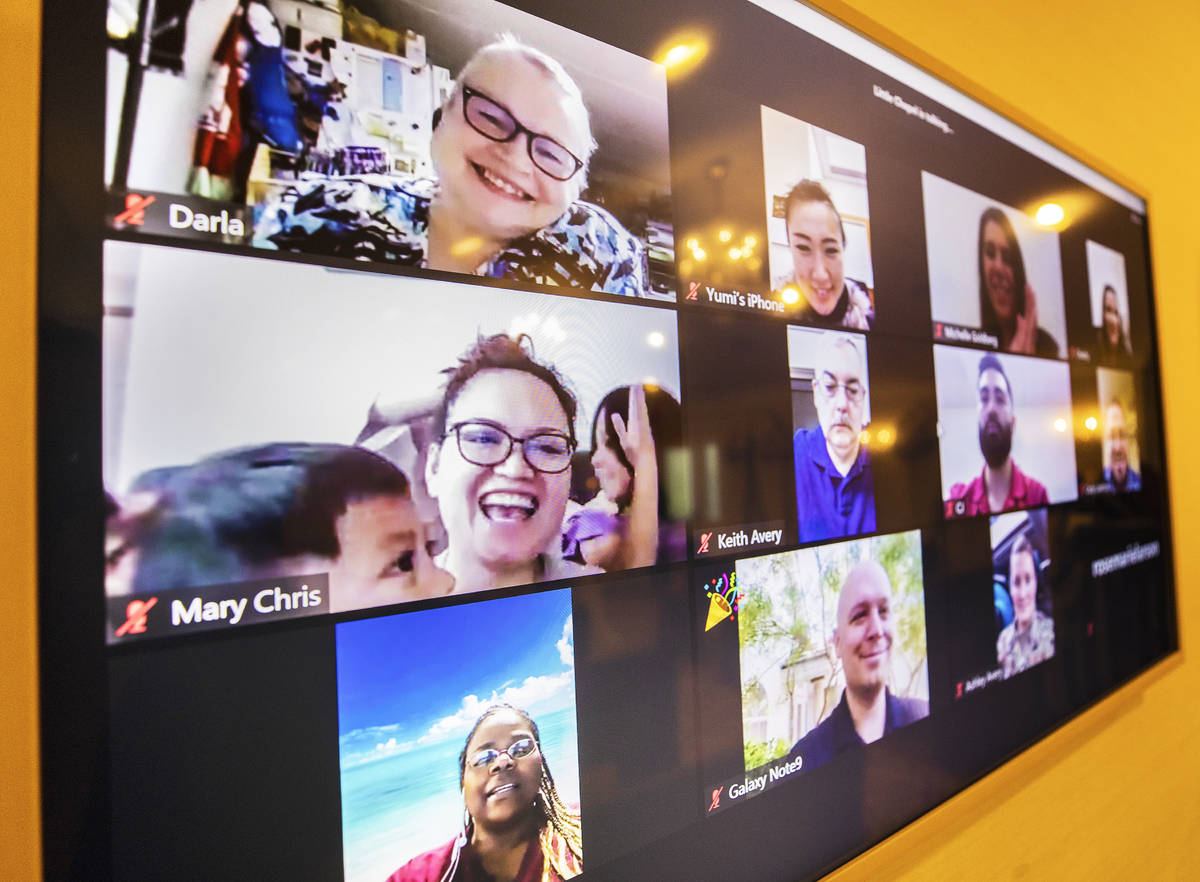 Friends and family cheer via Zoom during a virtual vow renewal ceremony for William and Brandi ...