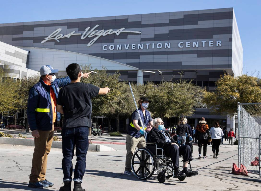 A FEMA employee, who declined to give his name, directs people to the Las Vegas Convention Cent ...