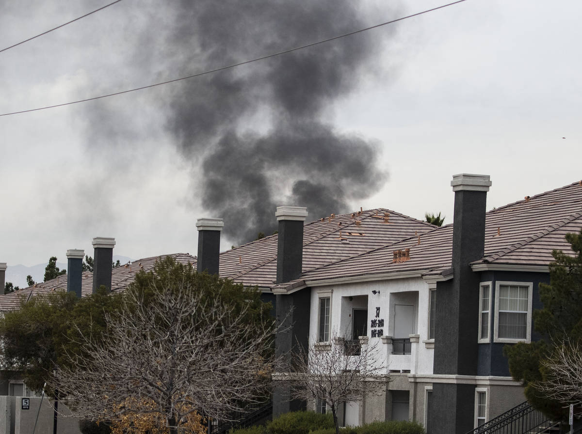 Black smoke is seen from an apartment at Milan Apartment Townhomes on East Silverado Ranch Boul ...