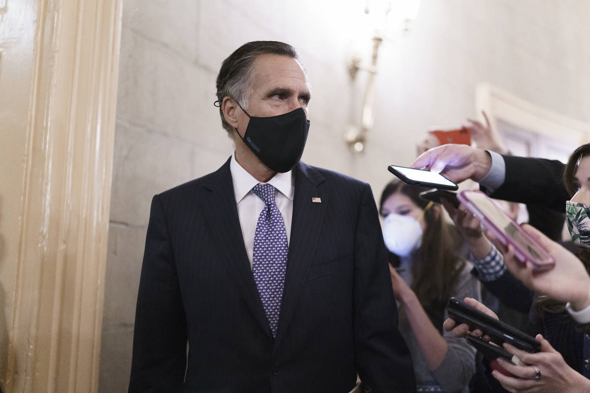 Reporters vie for a response from Sen. Mitt Romney, R-Utah, as Senators take a dinner break whi ...