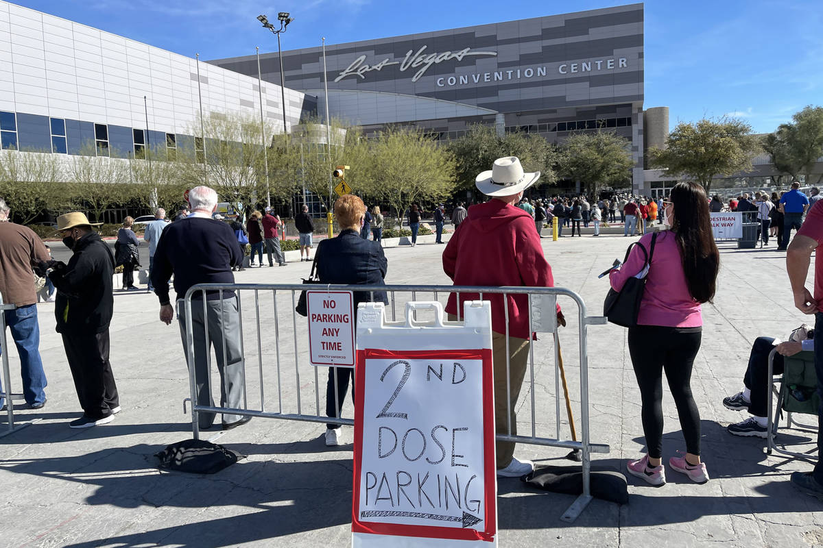 People line up for the second dose of the COVID-19 vaccine outside the Las Vegas Convention Cen ...