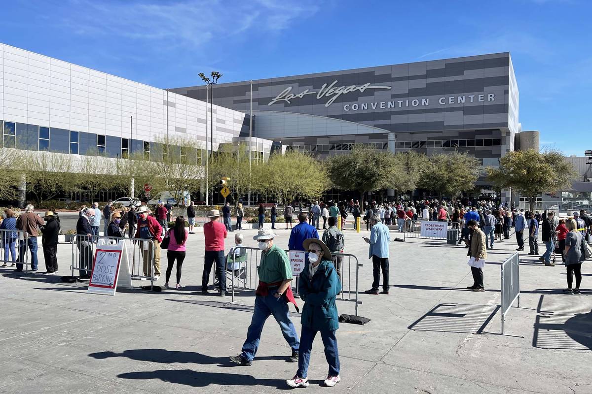 People line up for the second dose of the COVID-19 vaccine outside the Las Vegas Convention Cen ...