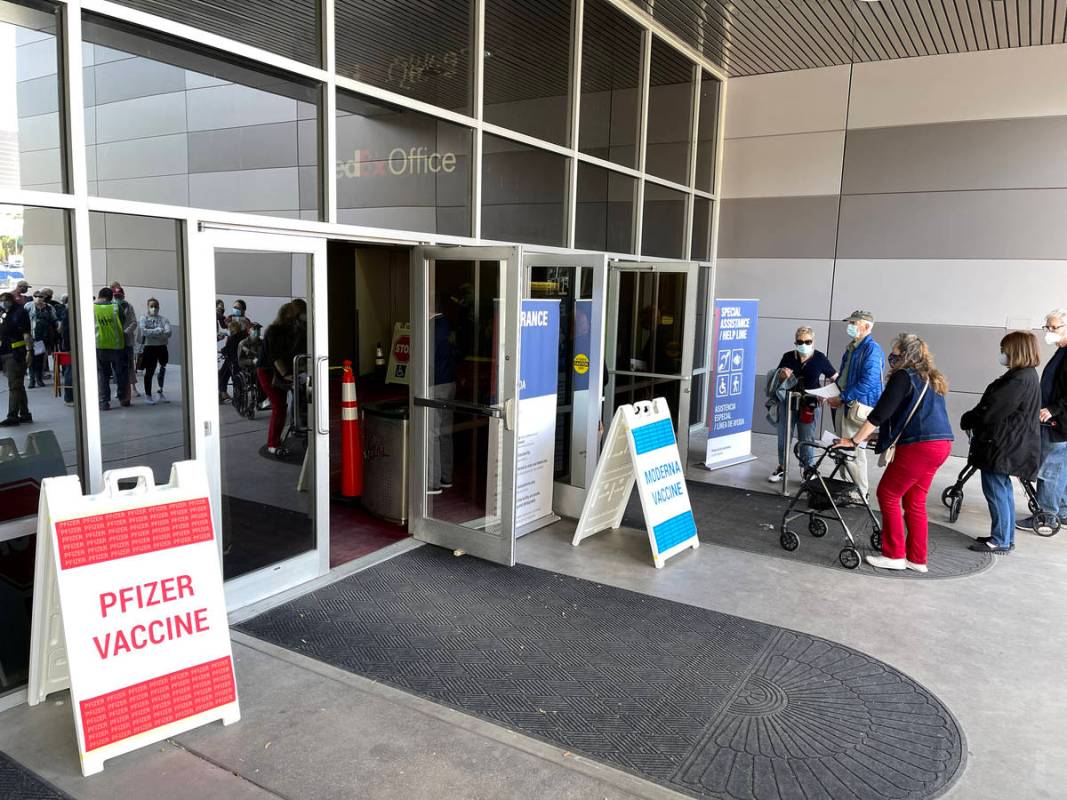 People line up for the second dose of the COVID-19 vaccine outside the Las Vegas Convention Cen ...