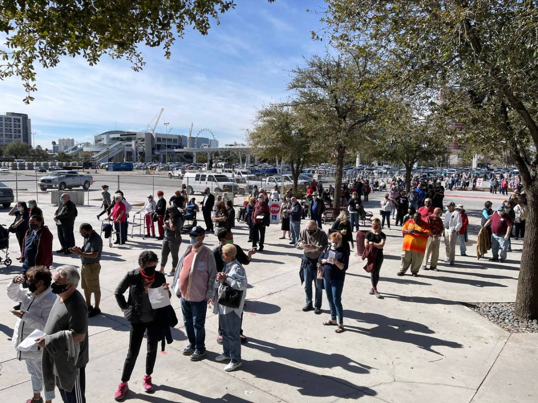 People line up for the second dose of the COVID-19 vaccine outside the Las Vegas Convention Cen ...