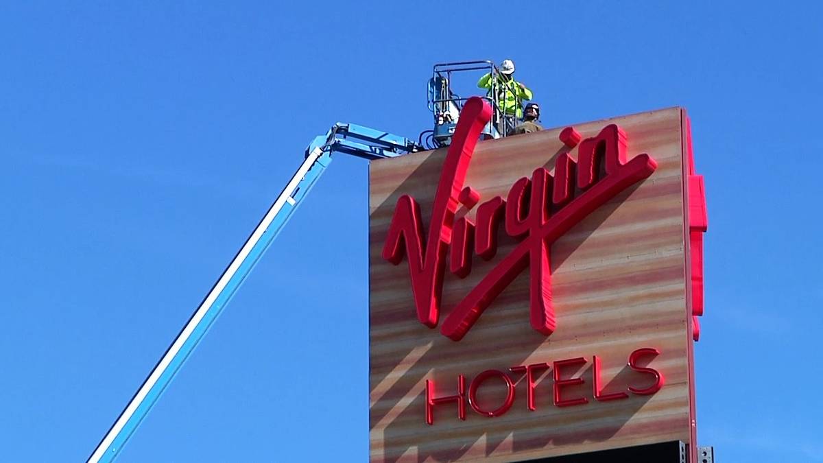 Construction continues as workers are lifted up to a sign on Feb. 11, 2021, at the Virgin Hotel ...
