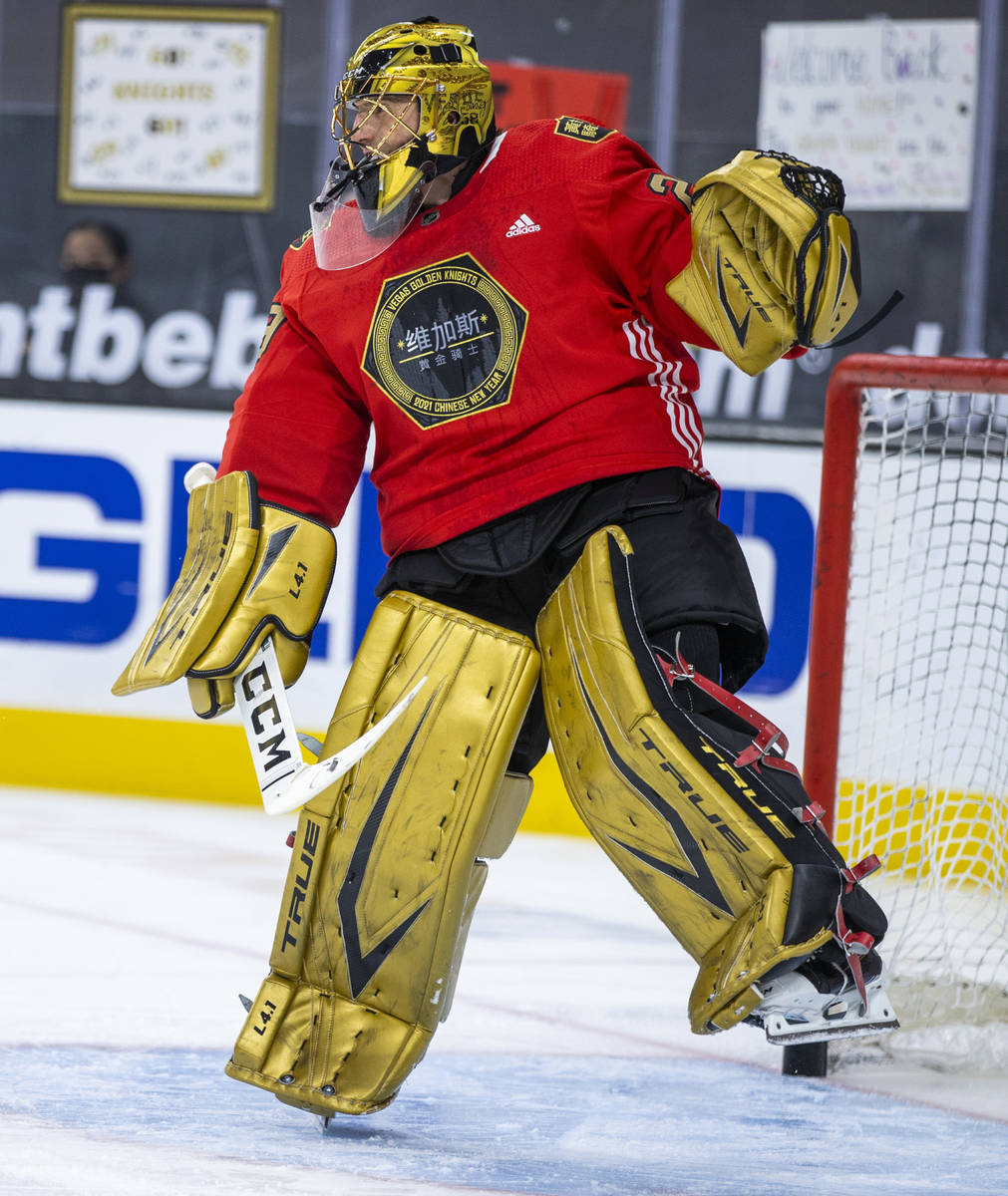 Golden Knights goaltender Marc-Andre Fleury (29) deflects a puck during warm ups before the fir ...