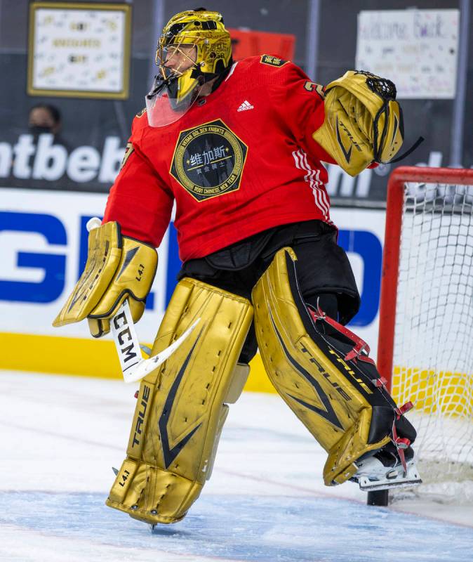 Golden Knights goaltender Marc-Andre Fleury (29) deflects a puck during warm ups before the fir ...