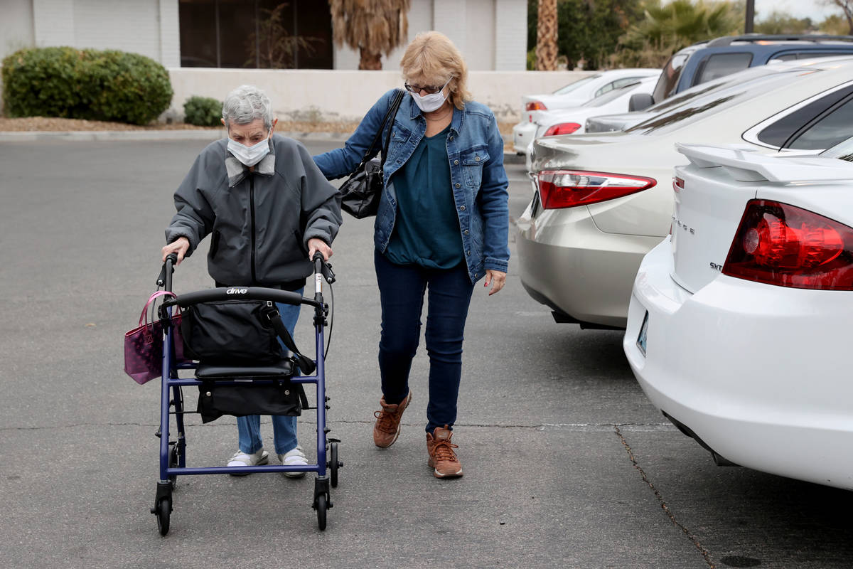 Estelle Roberts, 92, right, gets help from her daughter Dori Roberts-Lombardi, 65, before a doc ...