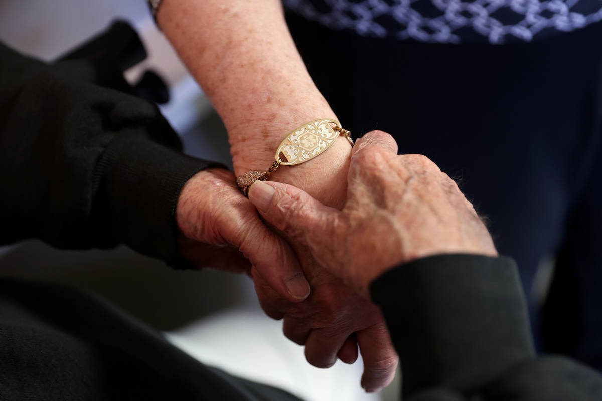 Don Masterson, 90, and Darlene Cox, 91, wait in line for the COVID-19 vaccine during an in-hous ...