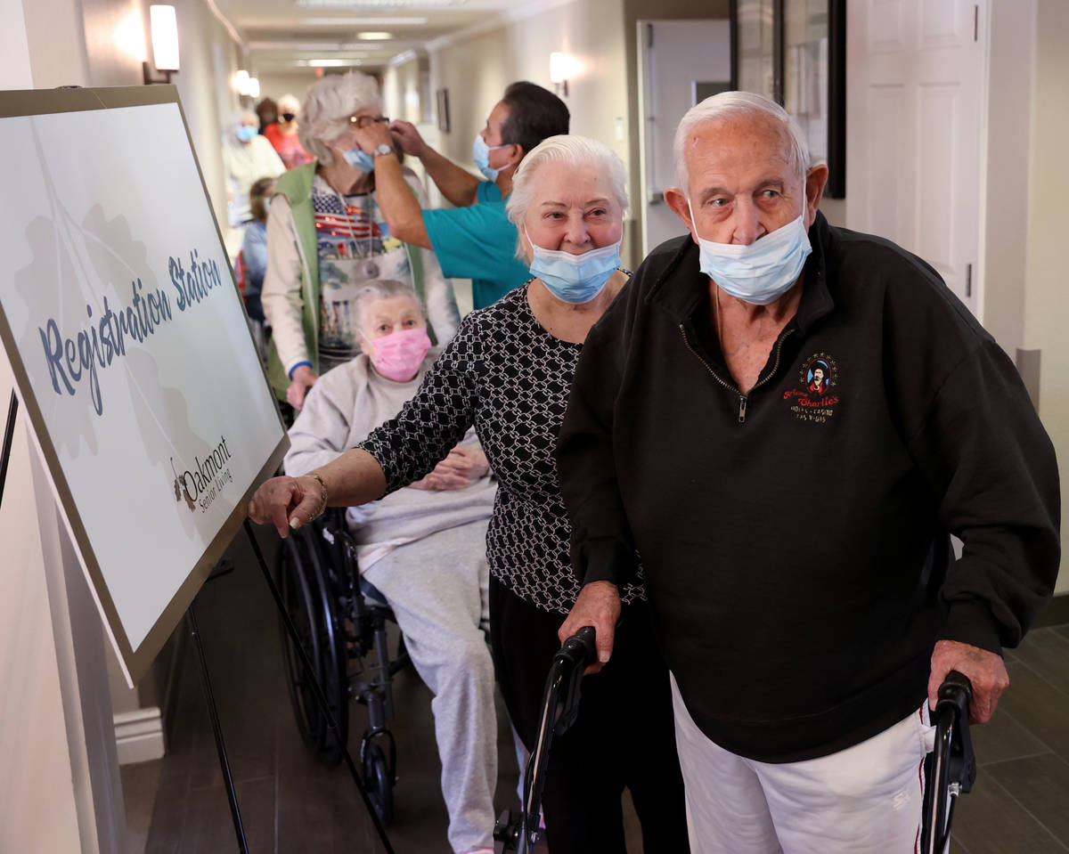 Don Masterson, 90, and Darlene Cox, 91, wait in line for the COVID-19 vaccine during an in-hous ...