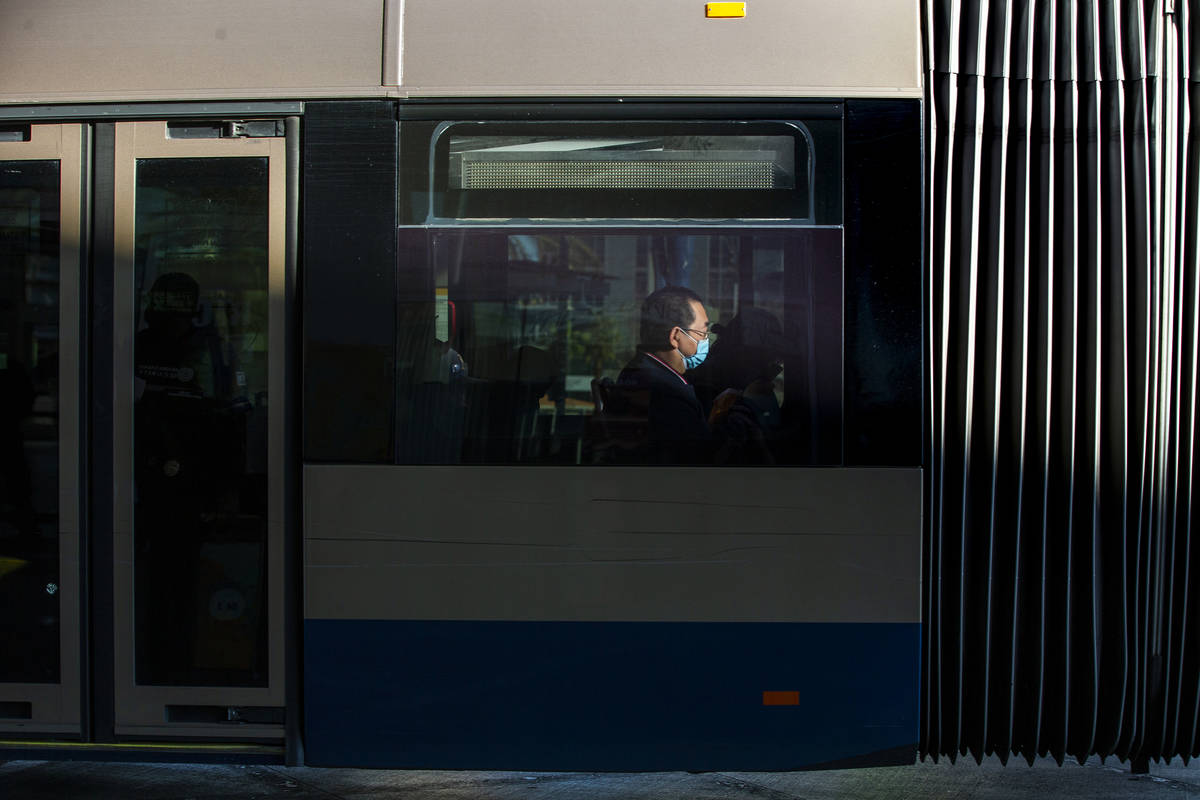 A passenger is lit by the late-day light on a bus at the Bonneville Transit Center operated by ...
