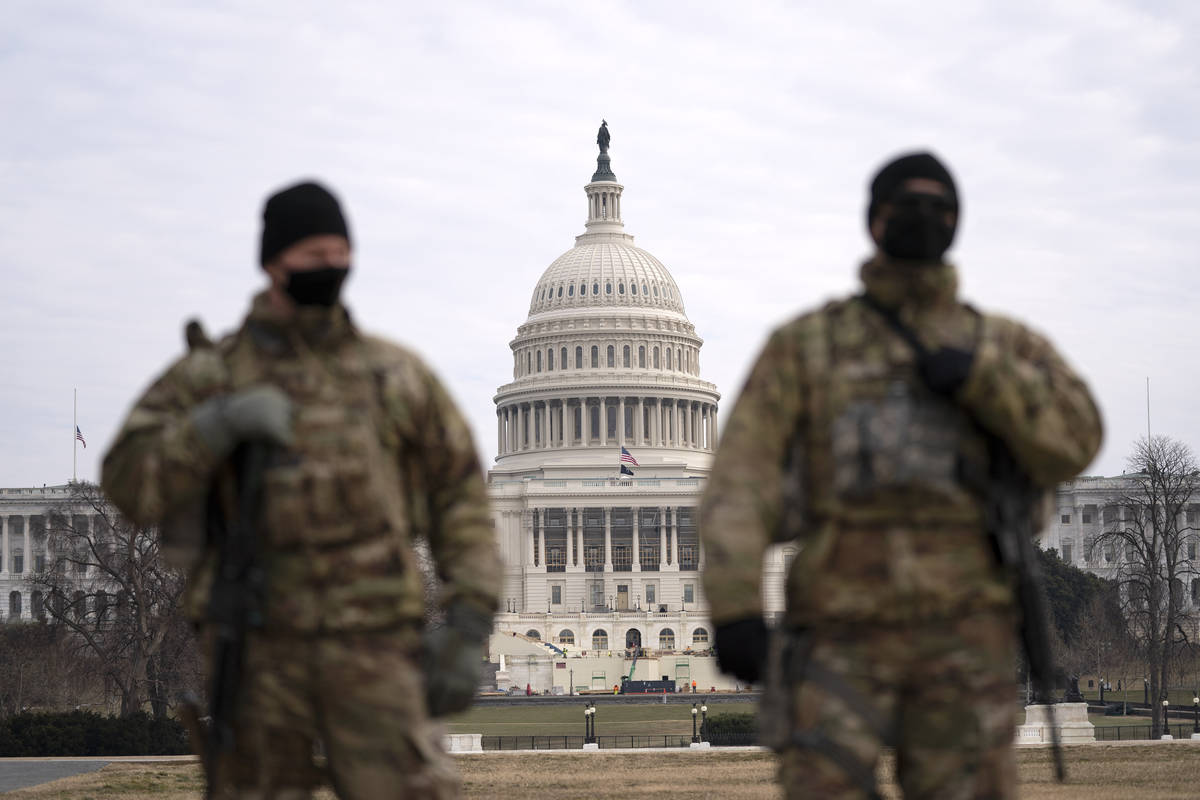 Members of the national guard patrol the area outside of the U.S. Capitol during the impeachmen ...