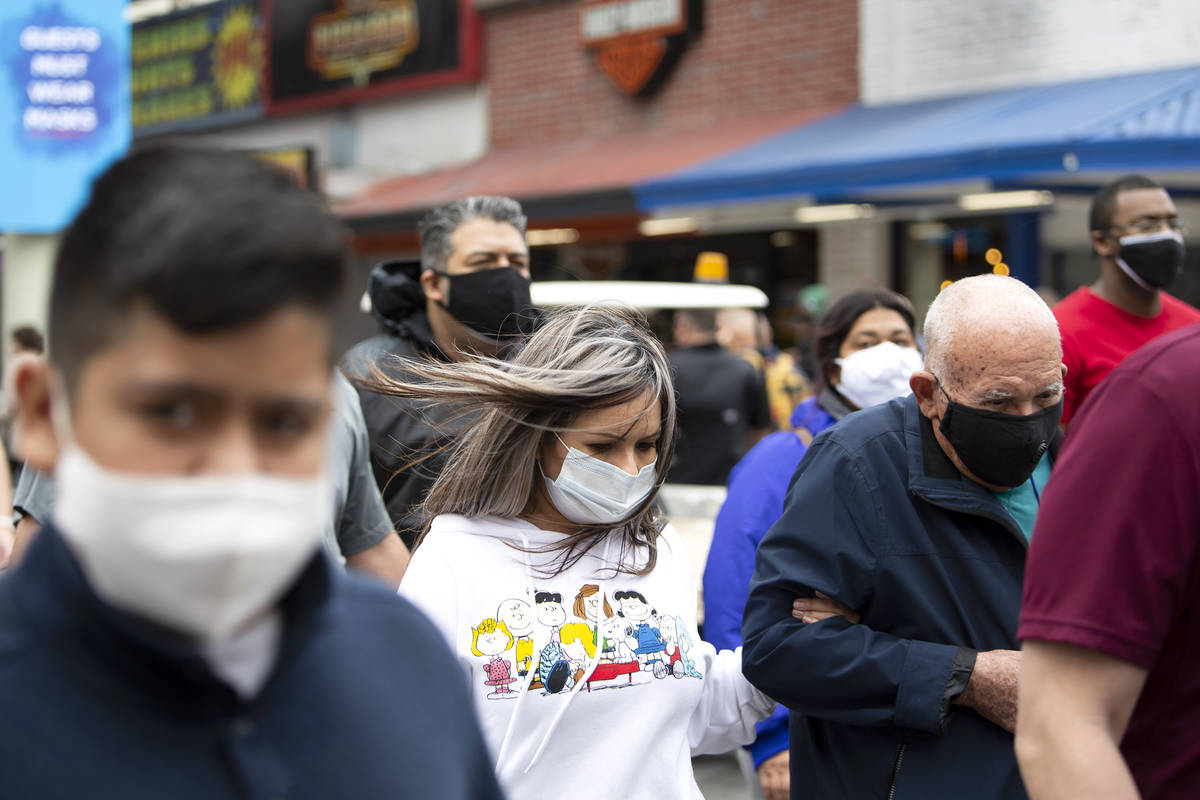 Wind blows the hair of one visitor to Fremont Street Experience on Saturday, Feb. 13, 2021, in ...