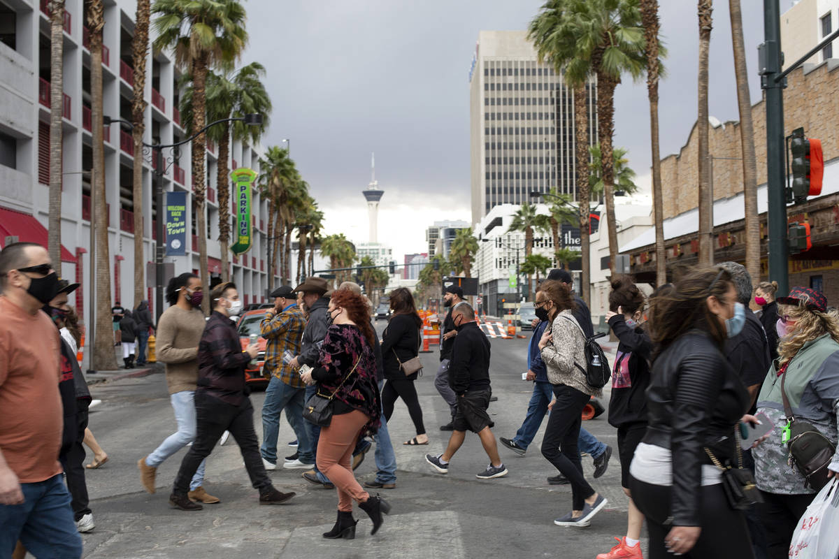 Visitors to Fremont Street Experience cross 4th Street after Clark County issued a severe thund ...