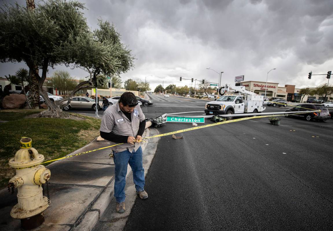 Heavy winds knocked down a power line at the intersection of West Charleston Boulevard and Sout ...