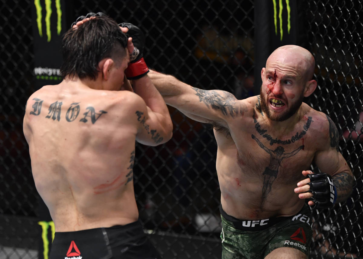 (R-L) Brian Kelleher punches Ricky Simon in their featherweight fight during the UFC 258 event ...