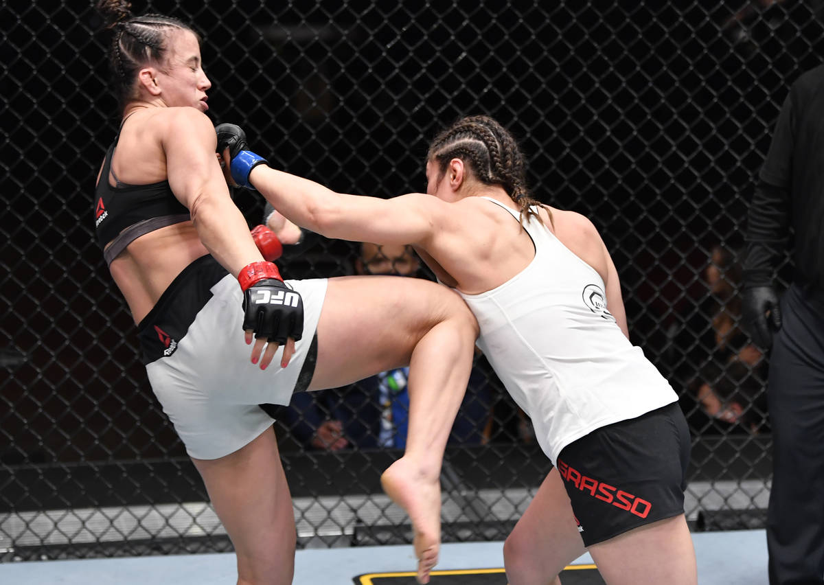 (R-L) Alexa Grasso of Mexico punches Maycee Barber in their flyweight fight during the UFC 258 ...