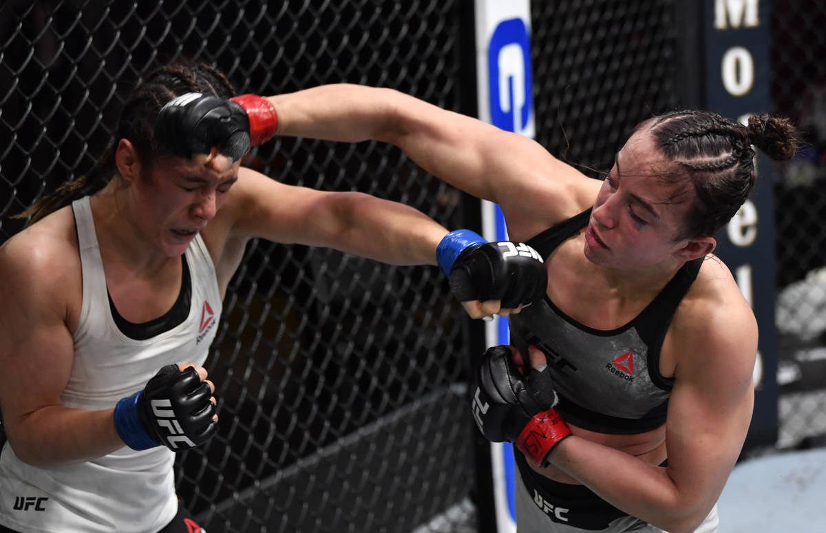 (R-L) Maycee Barber punches Alexa Grasso of Mexico in their flyweight fight during the UFC 258 ...