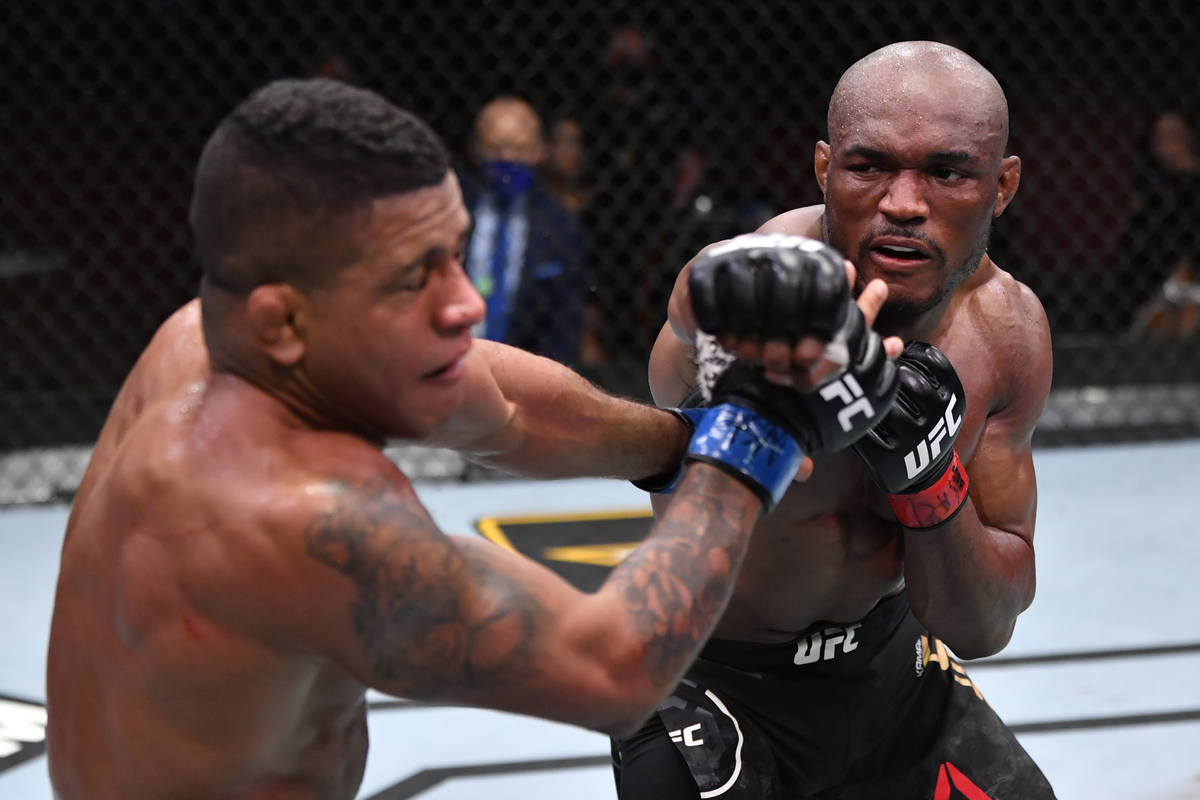 (R-L) Kamaru Usman of Nigeria punches Gilbert Burns of Brazil in their UFC welterweight champio ...