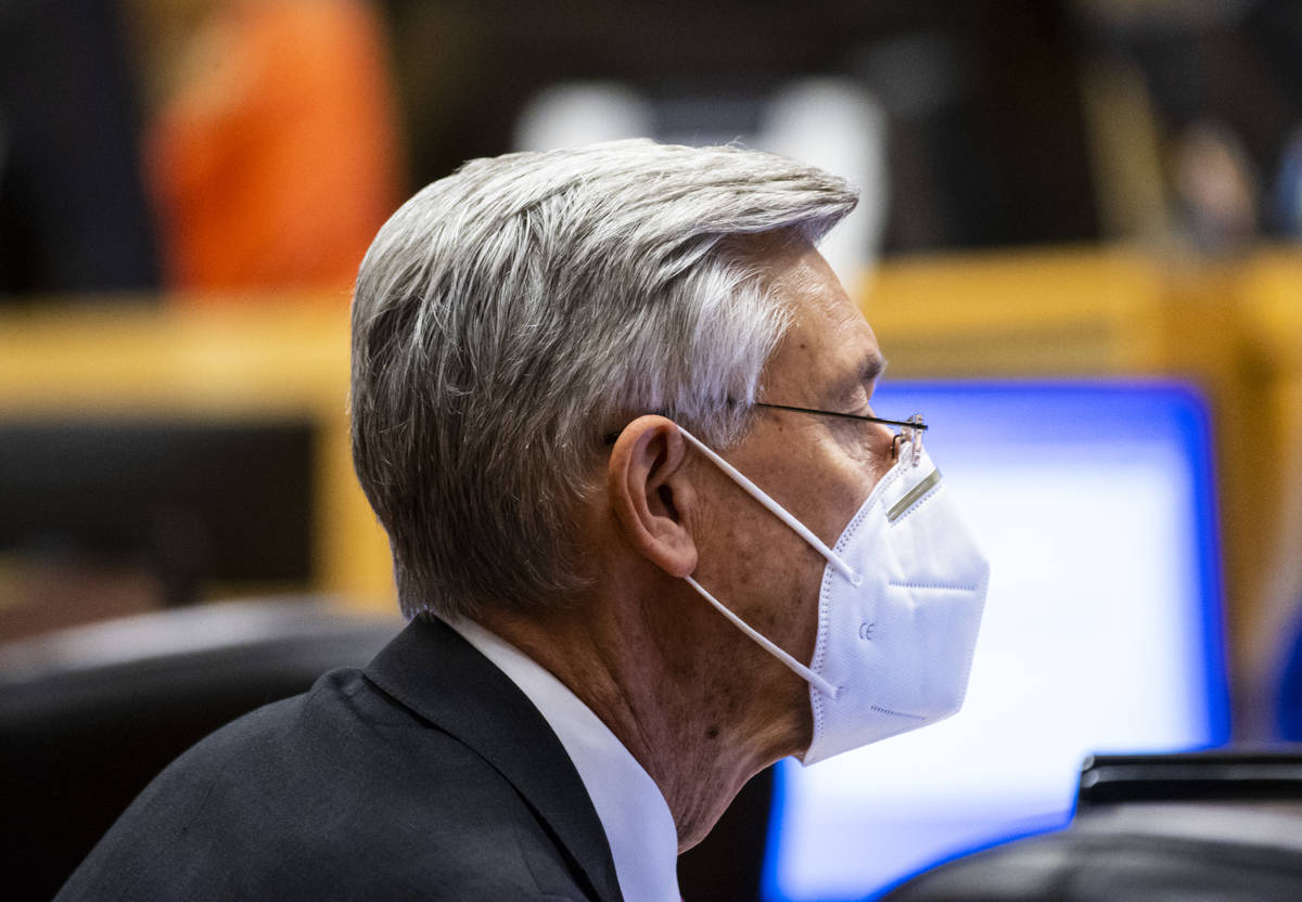 David Riggleman, communications director for the City of Las Vegas, wears a KN95 mask during a ...