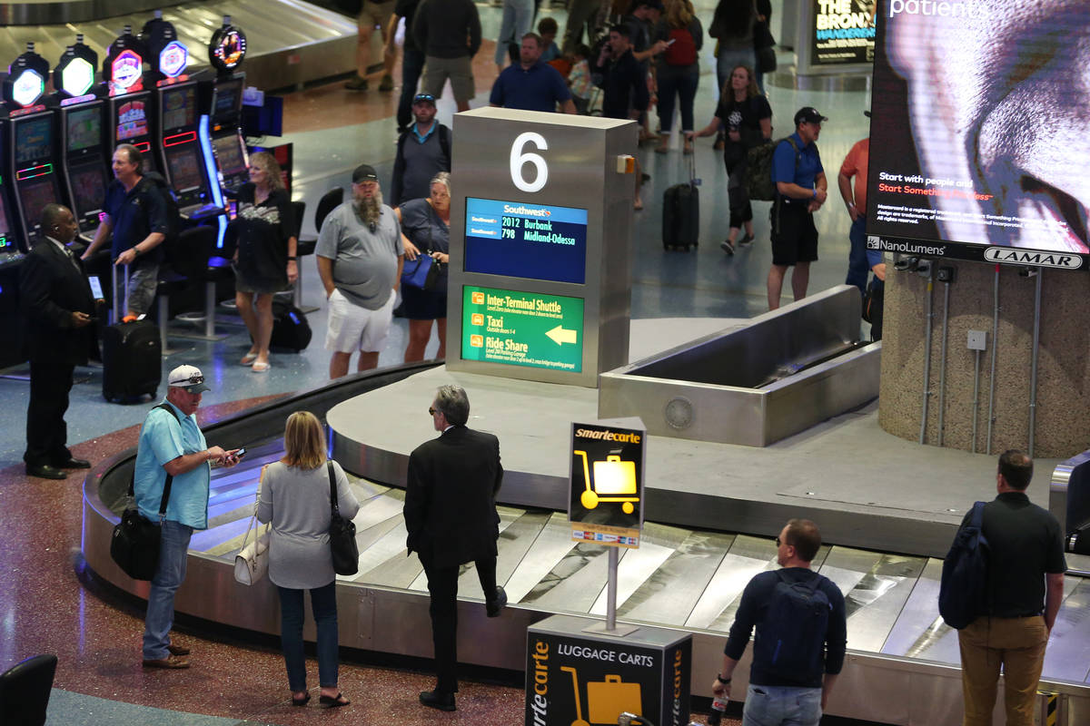 Passengers wait for their luggage in Terminal 1 at McCarran International Airport in Las Vegas. ...