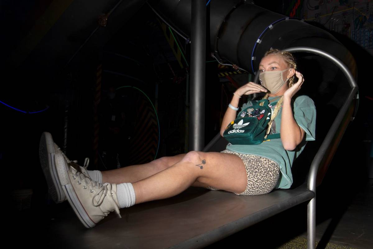 Allie Thompson, of Pennsylvania, reacts to one of the slides at the Omega Mart at Area15 on Thu ...