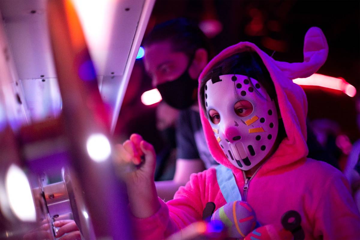 Jonate Spiewak, 7, wearing a Fortnite mask, intereacts with the art installation during opening ...
