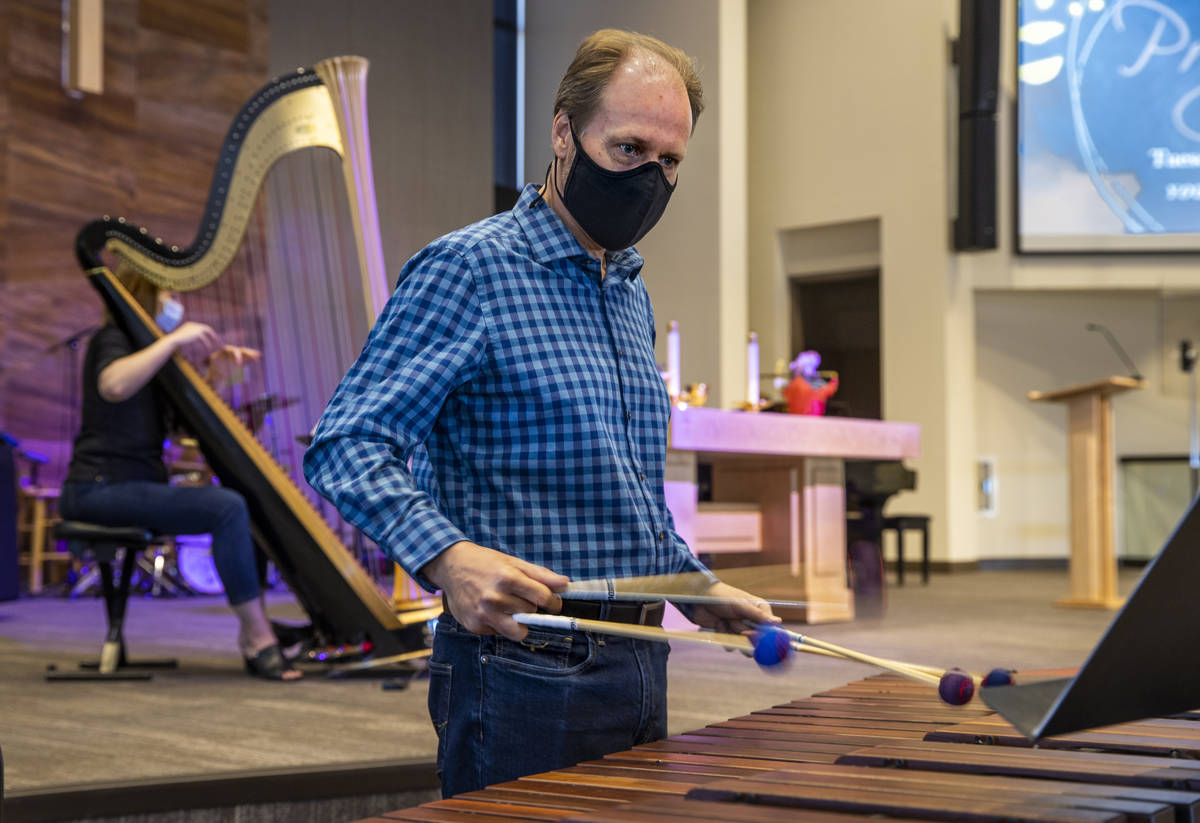Tim Jones plays the marimba as his wife, Melaney, plays the harp for an Ash Wednesday service a ...