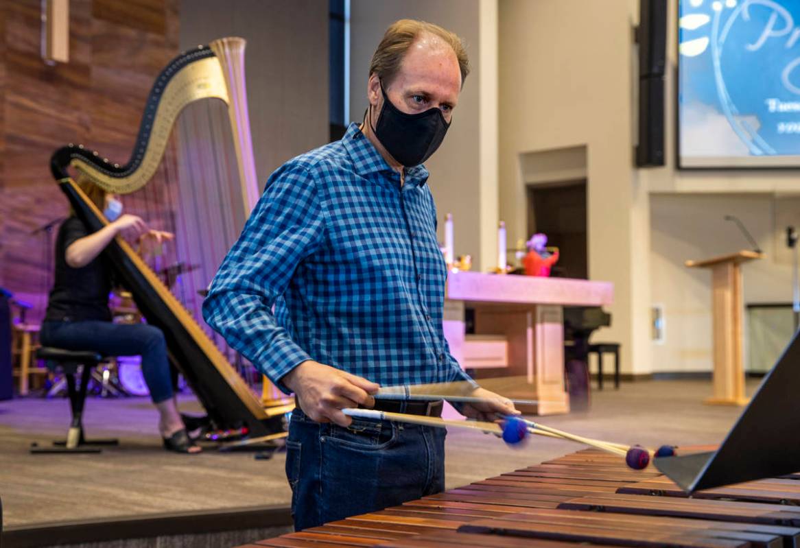 Tim Jones plays the marimba as his wife, Melaney, plays the harp for an Ash Wednesday service a ...