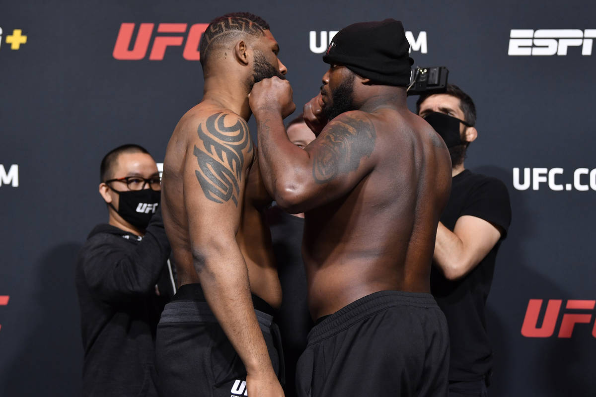 Curtis Blaydes, left, and Derrick Lewis face off during the UFC weigh-in at UFC APEX on Februar ...
